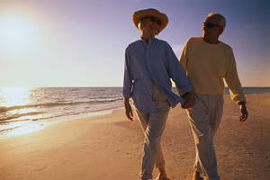 older couple walking on a beach